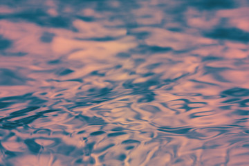 3D Rendering of water ripple surface in sunset red orange color theme. Providing sad, lonely, calm feeling. For background or wallpaper