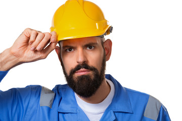 Builder in hard hat, foreman or repairman touching his helmet. Bearded man worker with beard in hard hat. Portrait architect builder, civil engineer working. Isolated
