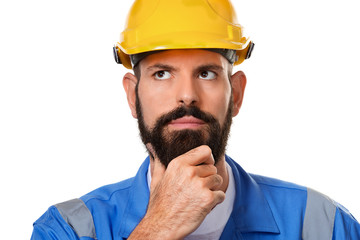 Thoughtful bearded builder in hard hat, foreman or repairman in the helmet. Close up portrait architect builder, civil engineer working over white background