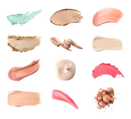 Set with swatches of lipsticks, eye shadows and skin foundations on white background, top view