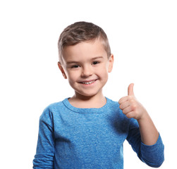 Little boy showing THUMB UP gesture in sign language on white background