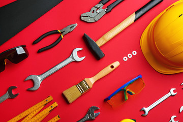 Flat lay composition with construction tools on color background