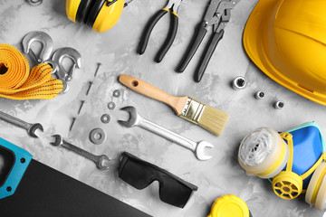 Flat lay composition with different construction tools on grey background