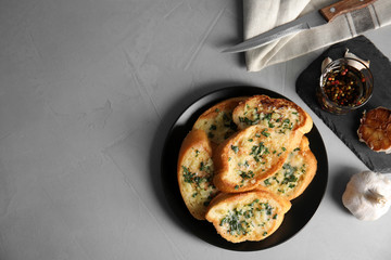 Flat lay composition with tasty garlic bread and space for text on table