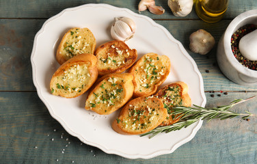 Flat lay composition with tasty homemade garlic bread on table