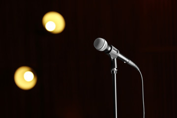 Obraz premium Microphone against festive lights, space for text