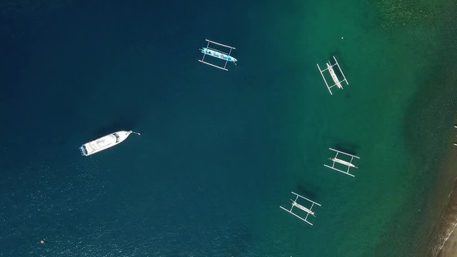 Top view of the Indonesian fishing boats in the blue sea.
