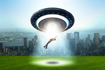 Flying saucer abducting young businessman 