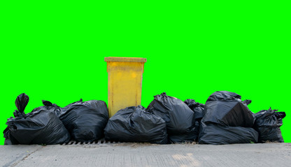 Black garbage bags on a green background