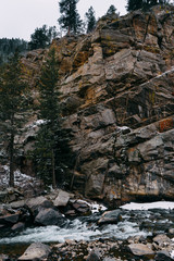 Colorado Rocky Mountains National Park. Bear Creek. Mountain river runs through the forest in the spring. Stones and rocks in the water