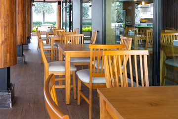 Wooden tables and chairs in restaurant.