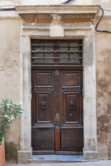 Fototapeta na wymiar Character filled old wooden door in St Remy de Provence, France