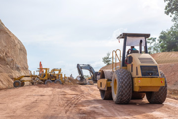 Soil or Tandem or Road vibratory compactor working on road work construction site.