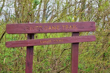 Trail and warning signs along the Shelby Bottoms Greenway and Natural Area Cumberland River frontage trails, Music City Nashville, Tennessee. United States.