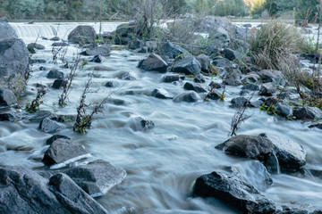 The Murrumbidgee River, looking upstream across a weir at Casuarina Sands Reserve, Canberra,...