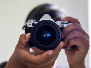 Men Photographer holding vintage lens 