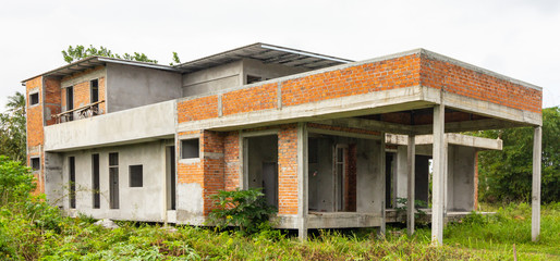 Unfinished single two storey house in housing estate. New modern house construction.