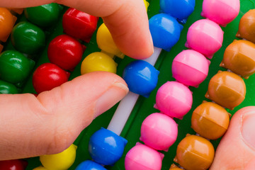 Hand using an abacus