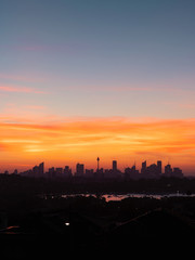 Fototapeta na wymiar Sydney skyline with red orange sunset sky.