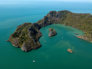 Aerial view of island in sea. Boat float near the island. Park Kilim Geforest, Langkawi, Malaysia. - obrazy, fototapety, plakaty