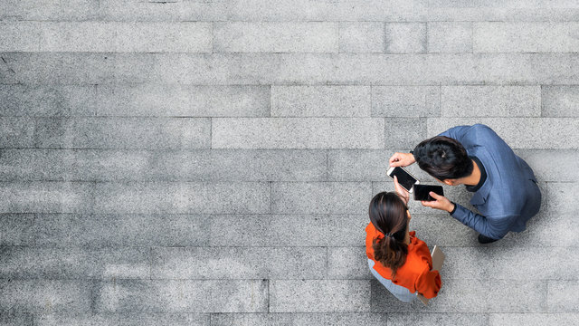 Top Aerial View Of Businessman And Woman People Meeting And Using Smartphone For Presentation At Outdoor Pedestrian City.