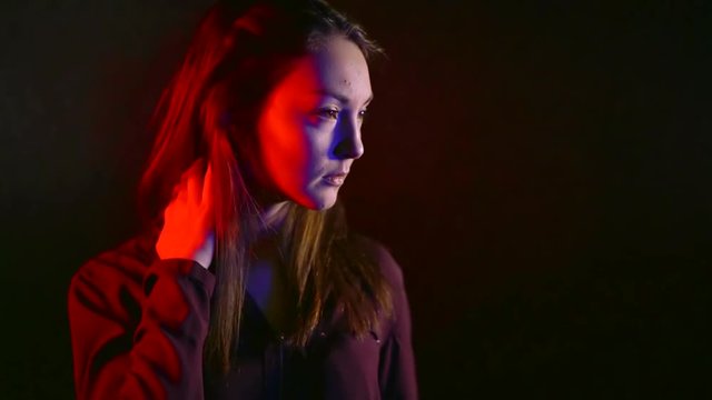 Seductive Asian woman in neon light Portrait of young girl in dark room