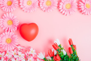 Red heart and flower on pink background