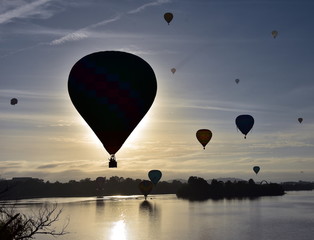 Canberra, Australia - March 10, 2019. Hot air balloons flying in the air above Lake Burley Griffin, as part of the Balloon Spectacular Festival in Canberra.