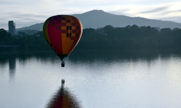Canberra, Australia - March 10, 2019. Hot air balloon flying in the air above Lake Burley Griffin, as part of the Balloon Spectacular Festival in Canberra.