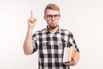 Geek, nerd and education concept - Handsome man in plaid shirt finger gesture up over white background