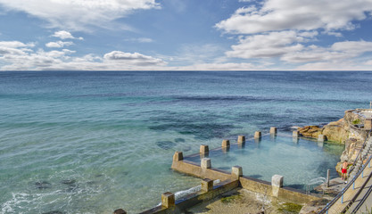 Man in red pant is ready to dive in a swimming pool near the beach in Bondi beach Australia