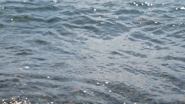 Gentle ocean waves reaching the beach