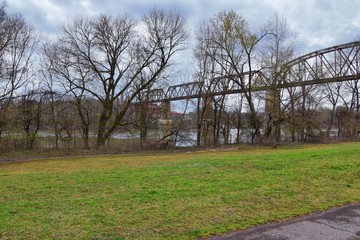 Fototapeta na wymiar Train track railway bridge views along the Shelby Bottoms Greenway and Natural Area over Cumberland River frontage trails, Music City Nashville, Tennessee. United States.