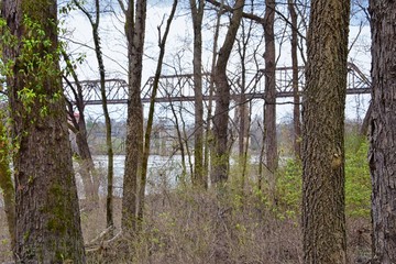 Train track railway bridge views along the Shelby Bottoms Greenway and Natural Area over Cumberland River frontage trails, Music City Nashville, Tennessee. United States.