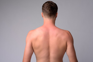 Fototapeta premium Rear view of young muscular man shirtless