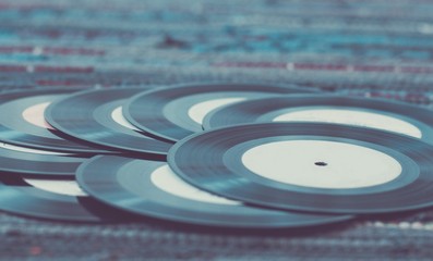 Old vinyl records, selective focus and toned image. Retro styled image of a collection of old vinyl records.