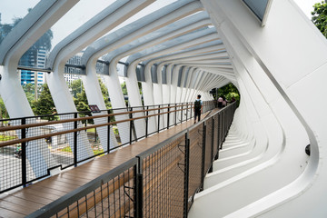 Pedestrian walks on the modern futuristic bridge