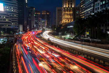 Obraz premium Trail lights from rush traffic at night time