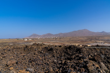 Spain, Lanzarote, Natural salt flats salinas de janubio between black lava and red mountains