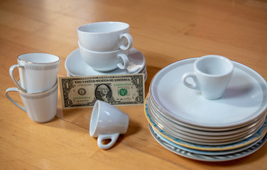 older dishes set with money on the floor