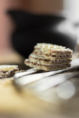 Sweet russian artek waffles on wooden background, with a pot of milk. Traditional sweets and dessert.