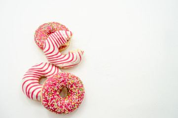 Donuts  frosted, pink glazed and sprinkles donuts isolated on white background