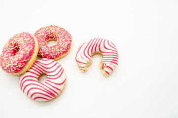 Donuts  frosted, pink glazed and sprinkles donuts isolated on white background