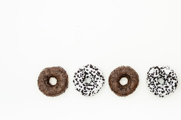 Donuts  with chocolate glazed with sprinkles donuts isolated on white black abstract background