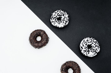 Donuts  with chocolate glazed with sprinkles donuts isolated on white black abstract background