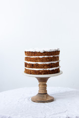 Delicious sliced carrot cake on white background with copy space