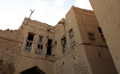 A corridor between ancient mud houses in the Sultanate of Oman