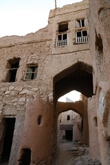 A corridor between ancient mud houses in the Sultanate of Oman