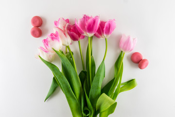 Pink and white bouquet of tulips on white background.