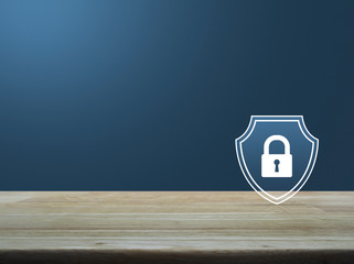 Padlock with shield flat icon on wooden table over light blue gradient background, Business security insurance concept